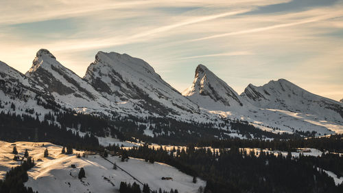 Scenic view of snowcapped mountains against sky during winter