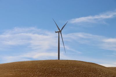 Single wind turbine blue sky minimal cloud