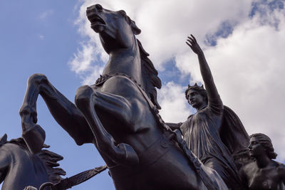 Low angle view of statue against cloudy sky