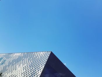 Low angle view of building against clear blue sky