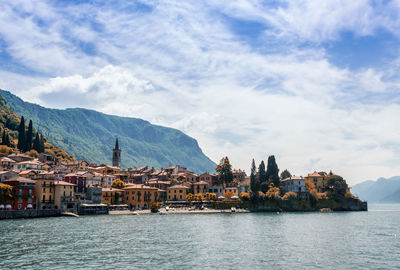 River with built structures against clouds