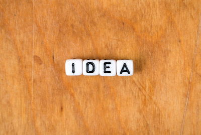 Close-up of information sign on wooden table