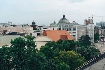 Panoramic view of buildings and trees against sky