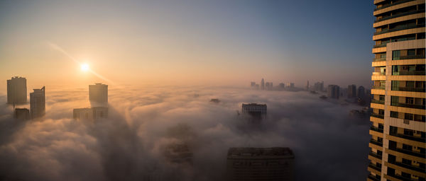 Aerial view of cityscape against sky during sunset