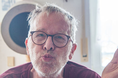 Close-up portrait of man wearing eyeglasses