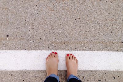 Low section of woman standing on beach