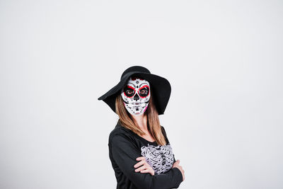 Portrait of woman wearing hat against white background