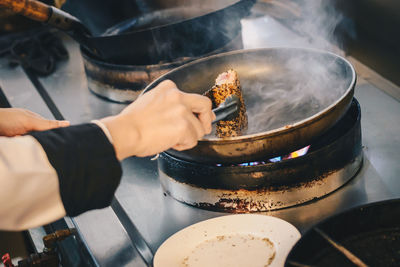 Midsection of person preparing food