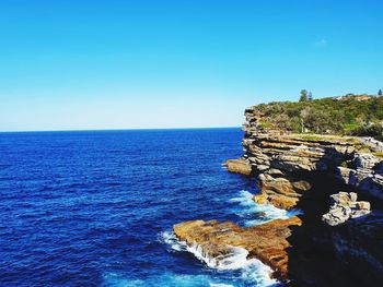 Scenic view of sea against clear blue sky