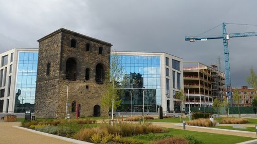 Buildings in city against sky