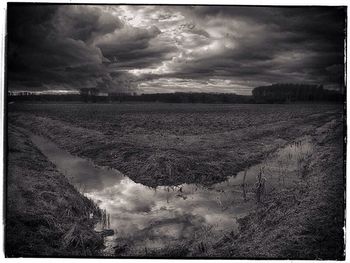 Scenic view of landscape against cloudy sky