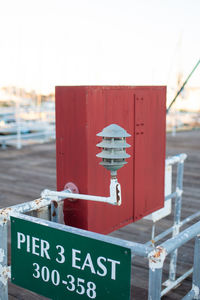 Close-up of information sign on pier