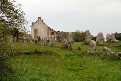 Old building on field against sky