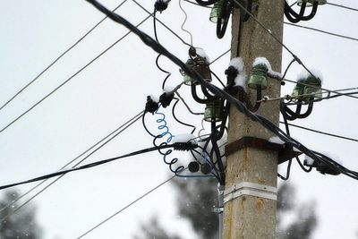 Low angle view of electricity pylon against sky