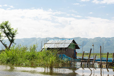 Scenic view of lake by building against sky