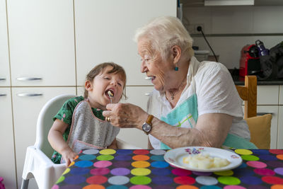 Happy friends sitting on table