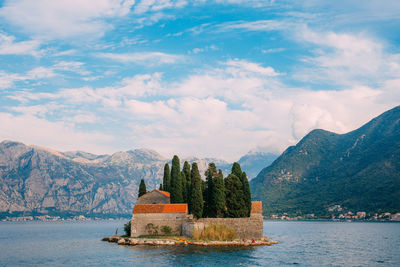 Scenic view of sea and mountains against sky