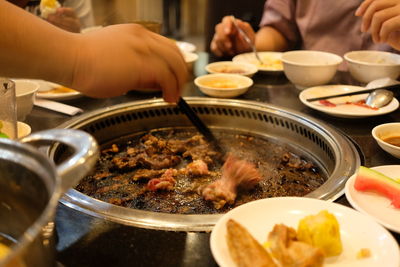 Close-up of person preparing food on table