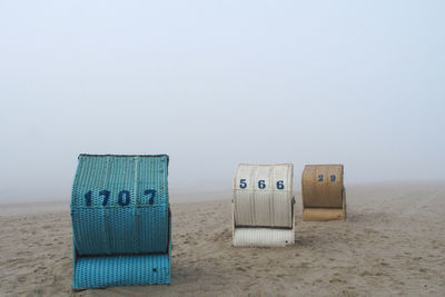 Hooded beach chair with numbers in foggy weather