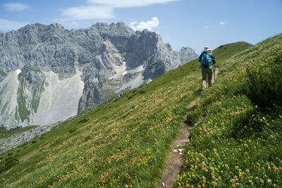 Full length of woman walking on trail against sky