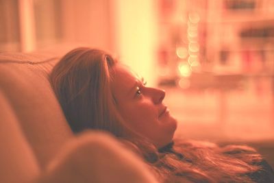 Portrait of woman looking away at home