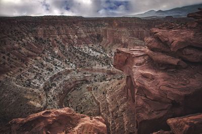 View of rock formation against cloudy sky