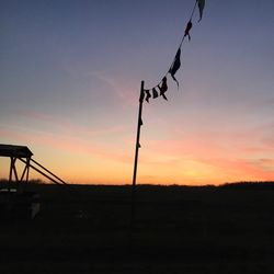 Silhouette of windmill against sky during sunset