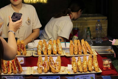 Man preparing food at market stall