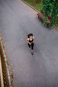 Aerial view of female athlete running on a road