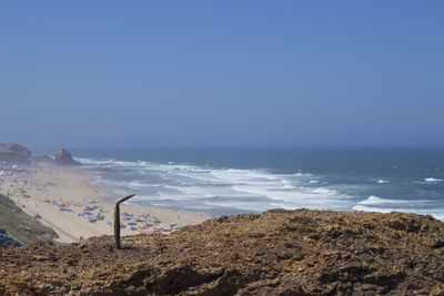 Scenic view of beach against clear blue sky
