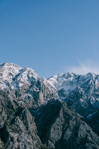 Scenic view of snowcapped mountains against clear blue sky