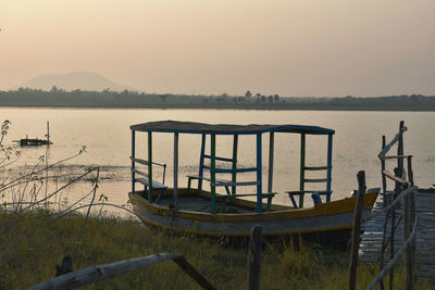 Scenic view of lake against clear sky at sunset