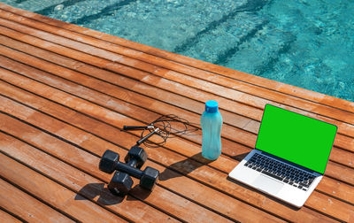 High angle view of laptop on swimming pool