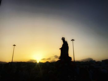 Silhouette of statue during sunset