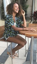 Young woman sitting on table