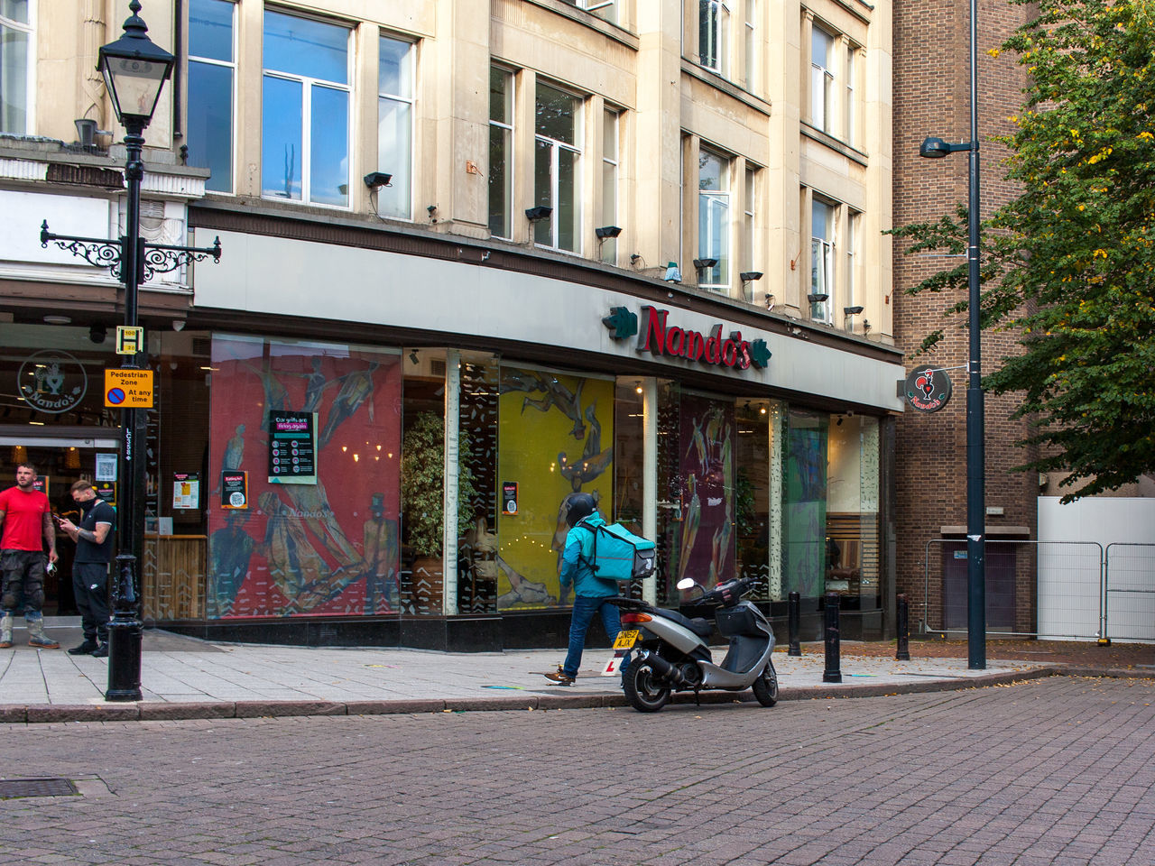 PEOPLE ON STREET BY BUILDING IN CITY