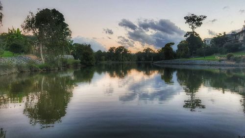 Scenic view of lake against sky at sunset