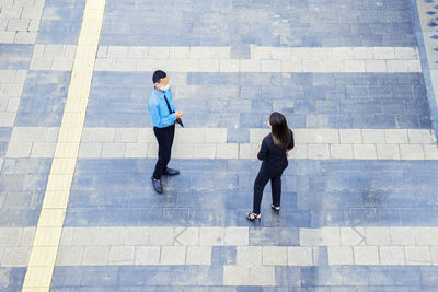 High angle view of people walking on zebra crossing