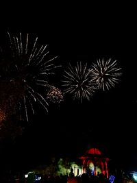 Low angle view of firework display at night