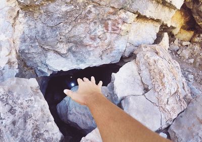 Low section of person standing on rock