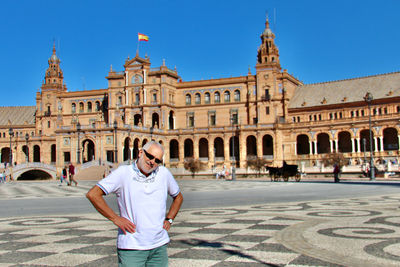 Full length of man walking in front of historical building