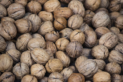 Close up crusty walnuts in bulk