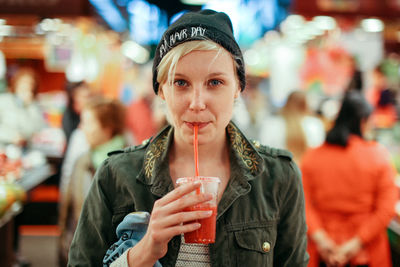 Portrait of woman sipping drink