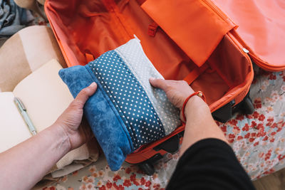 Cropped hand of woman packing bag