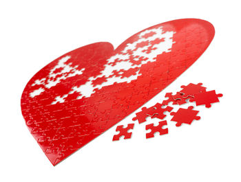 Close-up of red heart shape on white background