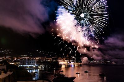 Firework display over city at night