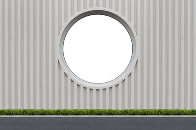 White wall and building against sky