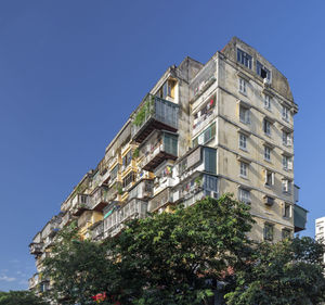 Low angle view of building against clear blue sky