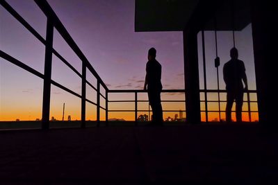 Silhouette of people at sunset