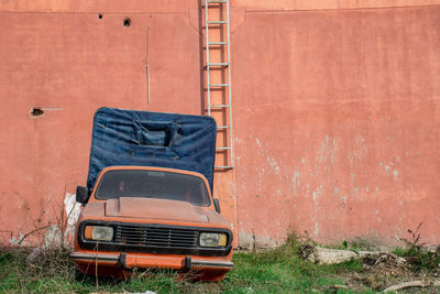 Abandoned truck against brick wall